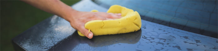 car being washed with a yellow rag